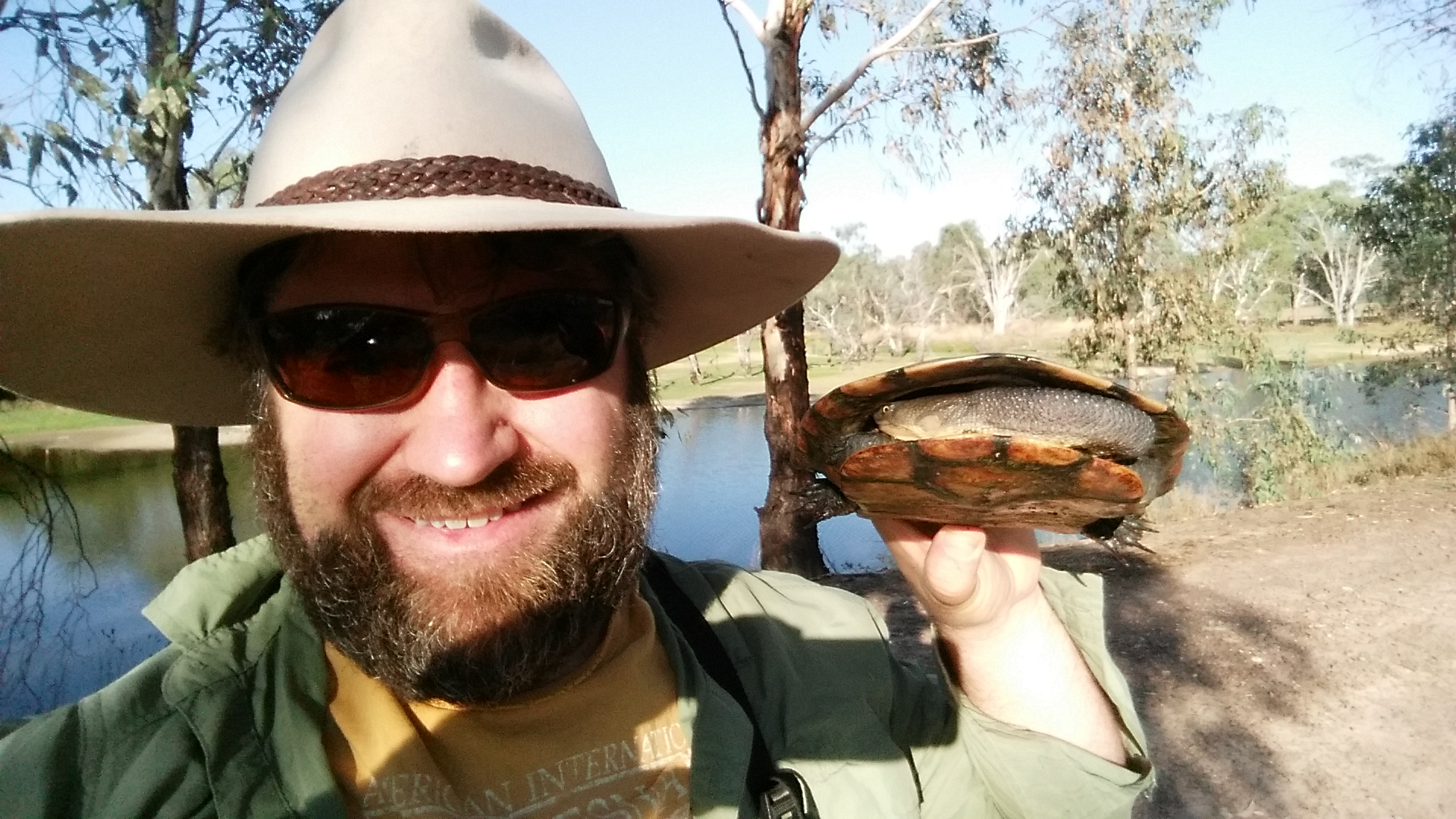 Charles Sturt researcher holding a turtle